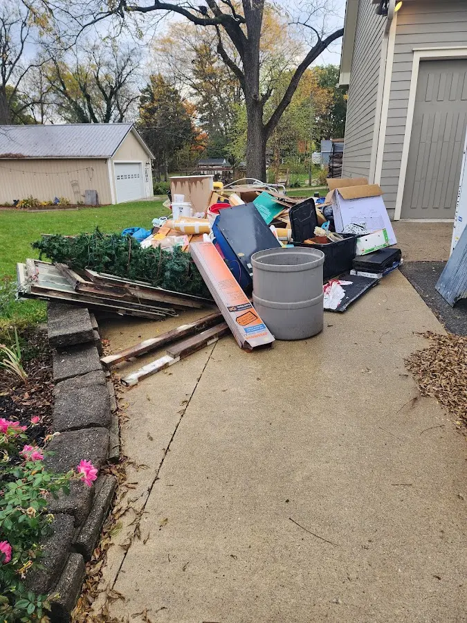 Dumpster being loaded with debris for 12 Yard Dumpster Rental in Durham